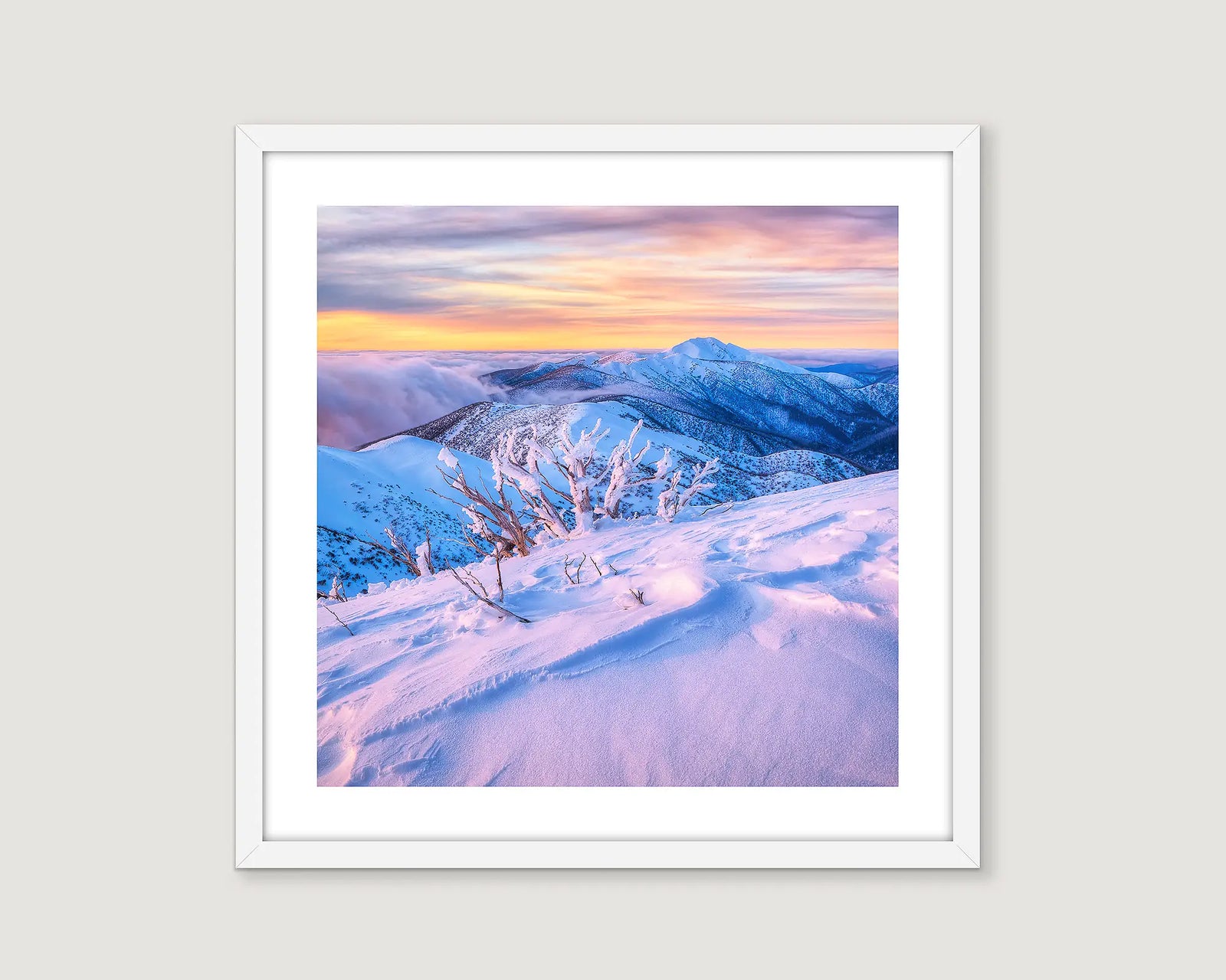 Framed photograph of Mount Feathertop covered in snow with a golden sunrise.