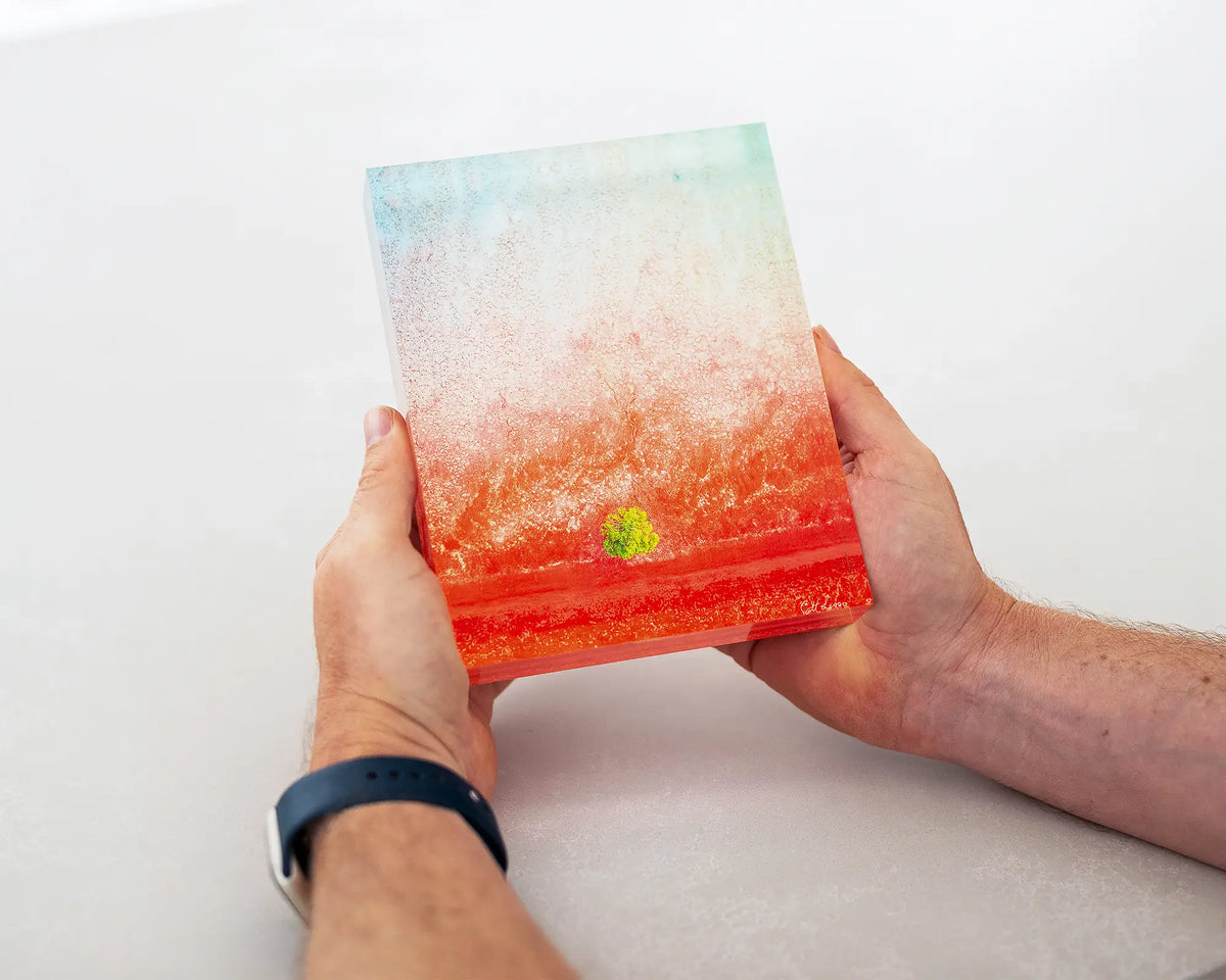 Mini. Acrylic block aerial artwork of Broome, The Kimberley, held in hands.