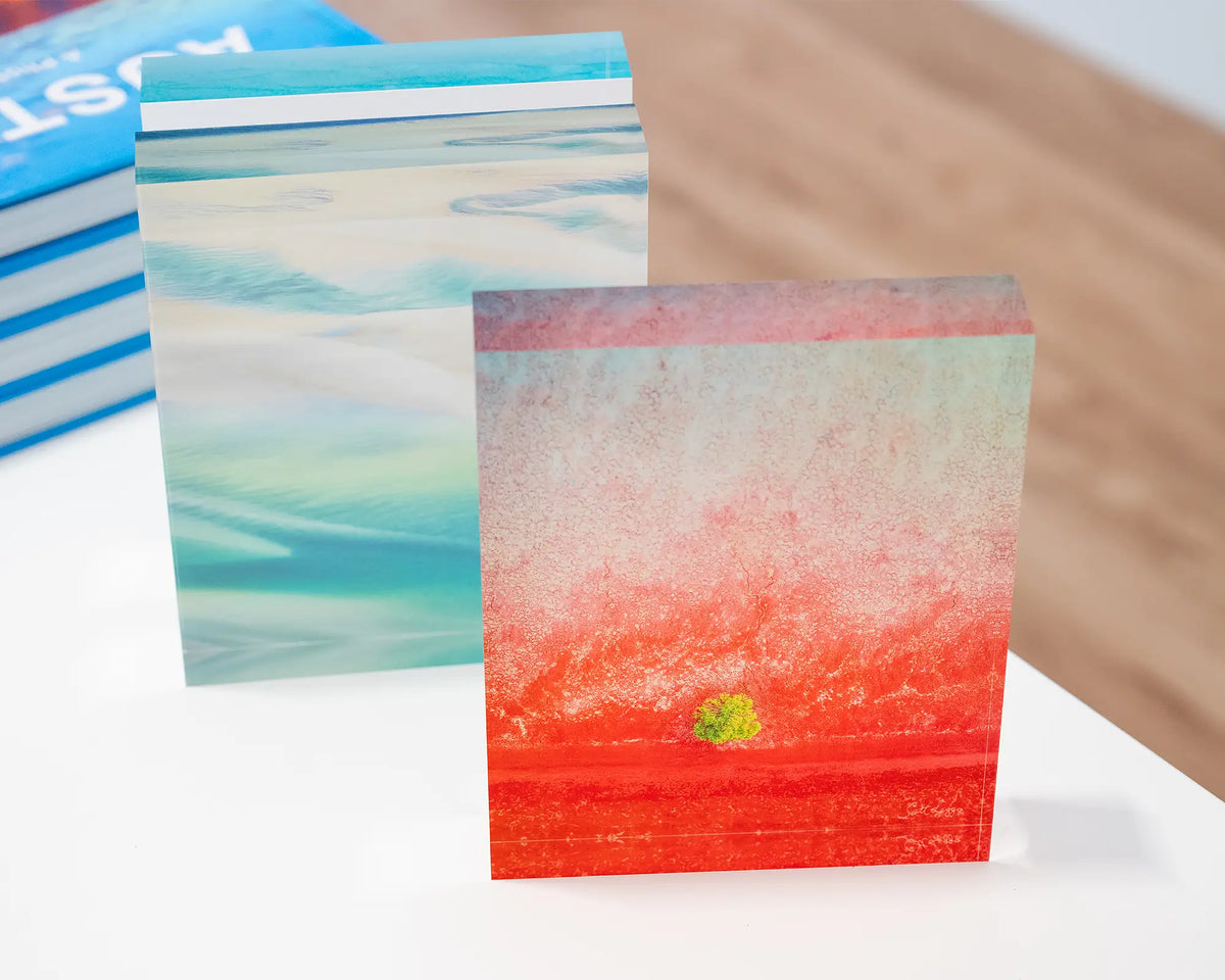 Mini. Acrylic block aerial artwork of Broome, The Kimberley, in gallery with coastal blocks and books.