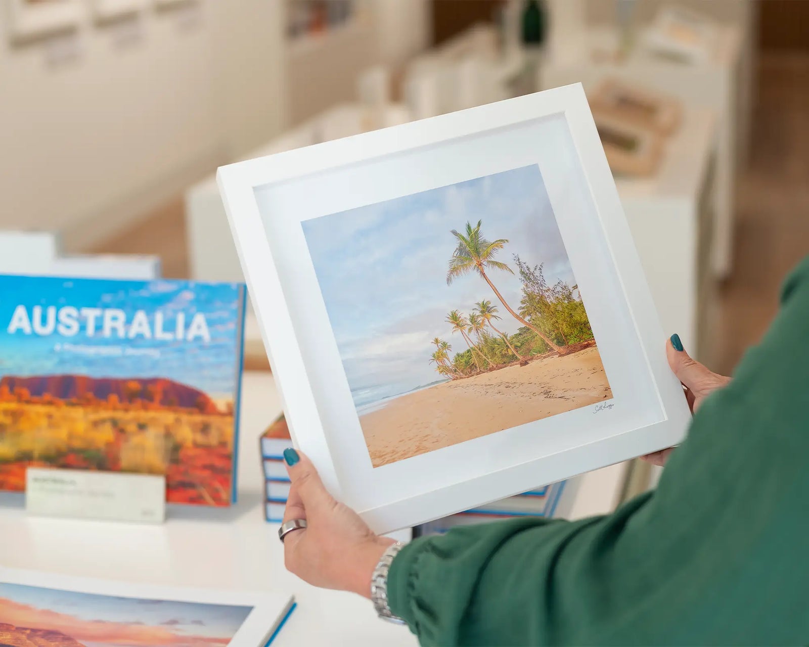 Framed photograph of palm trees on a beach.