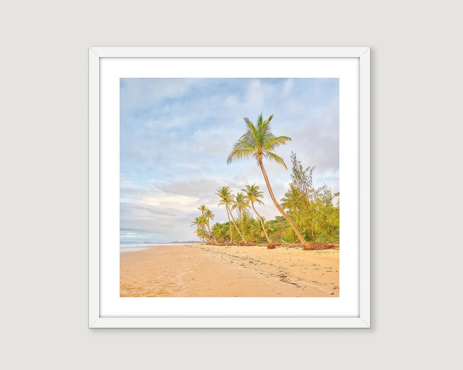 Framed photograph of palm trees on a beach.