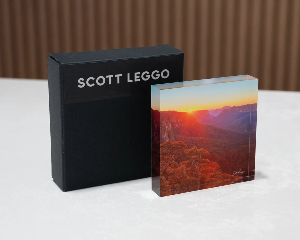Moment In Time. Acrylic block of sunrise over Grose Valley, Blue Mountains National Park, on desk with gift box.