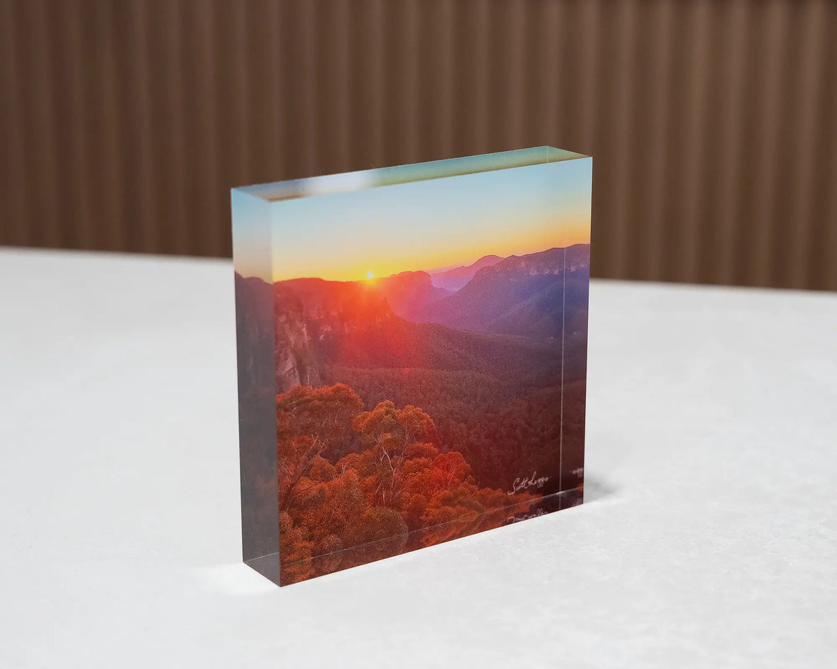 Moment In Time. Acrylic block of sunrise over Grose Valley, Blue Mountains National Park, sitting on a desk.