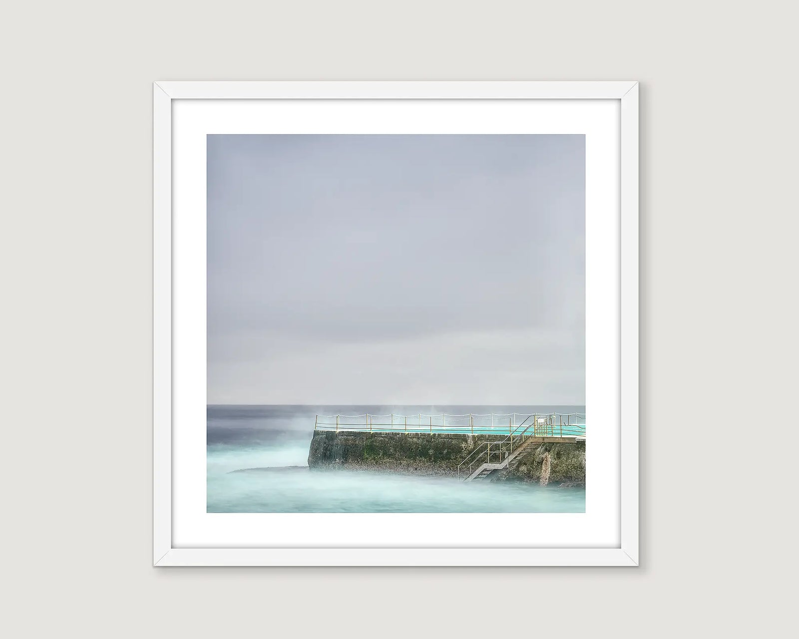 Framed photograph of Icebergs Bondi on a cloudy day.