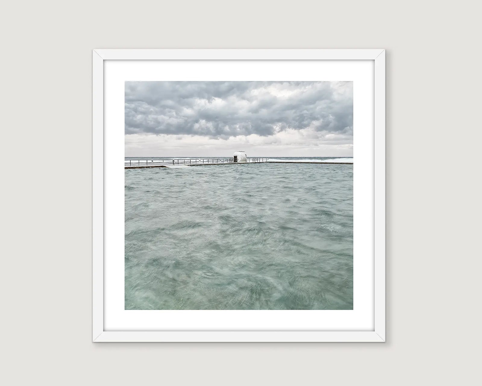 Framed photograph of Merewether Ocean Baths on a cloudy day.