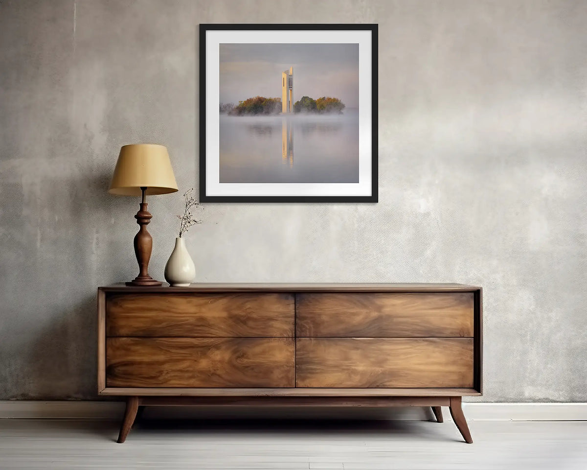 Morning Fog. Wall art print of the National Carillon in Canberra, framed with a black frame, and hung above a side table. 