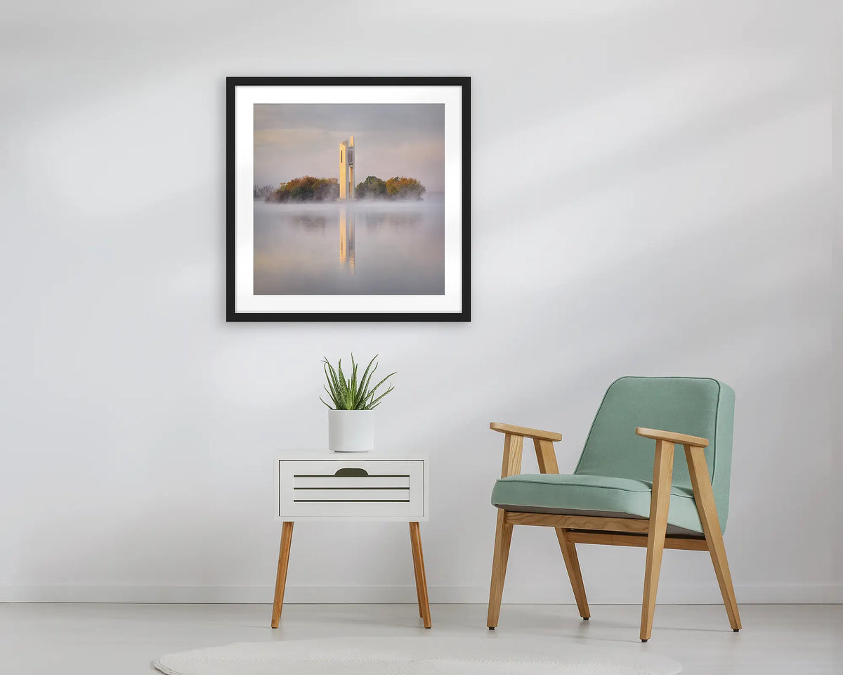 Morning Fog. Wall art print of the National Carillon in Canberra, framed with a black frame, and hung above a small table. 