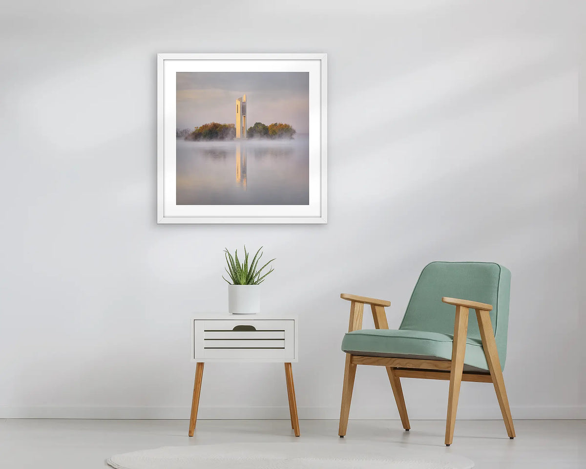 Morning Fog. Wall art print of the National Carillon in Canberra, framed with a white frame, and hung above a small table. 