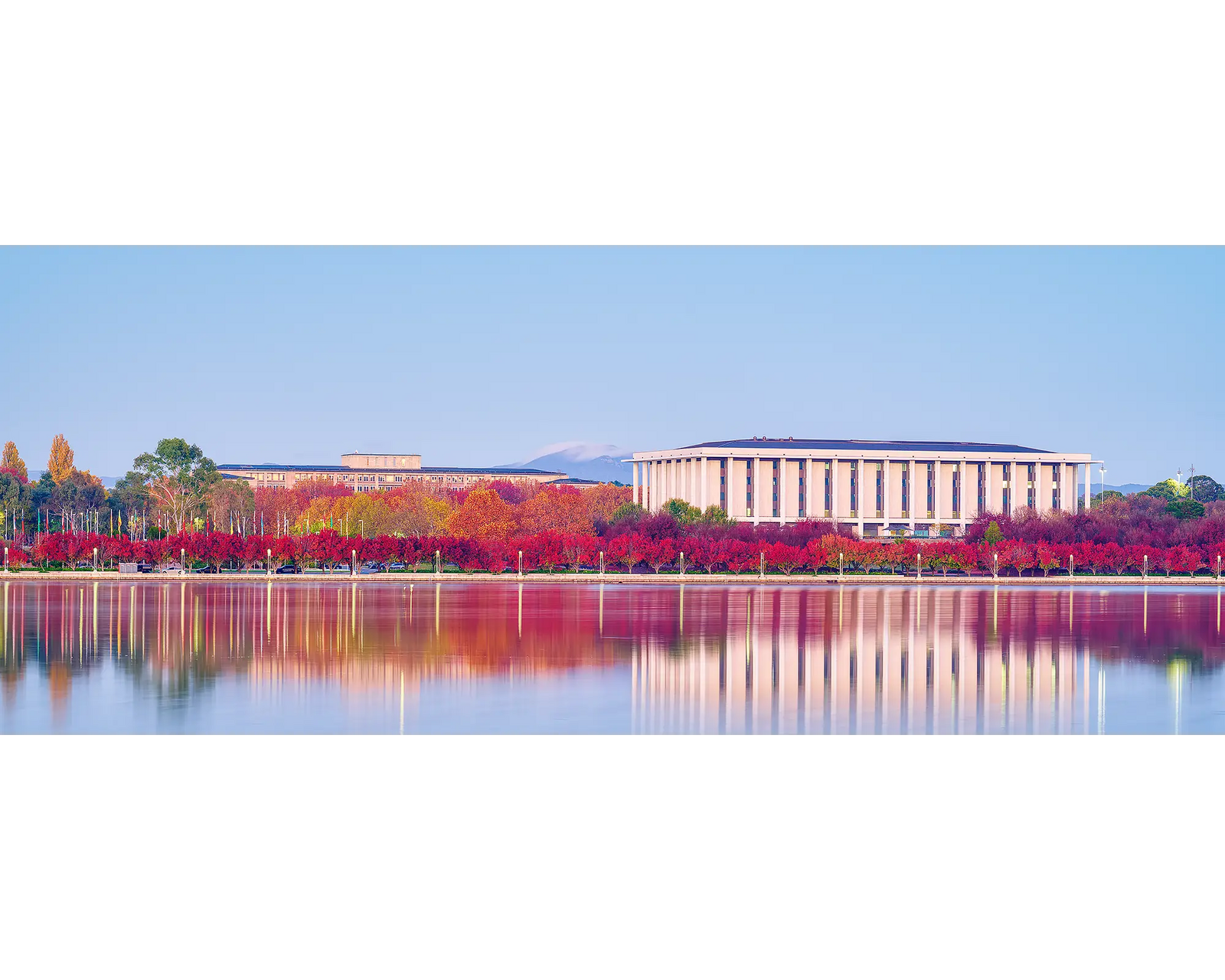 Morning Reds. National Library with red autumn colours reflecting in Lake Burley Griffin.