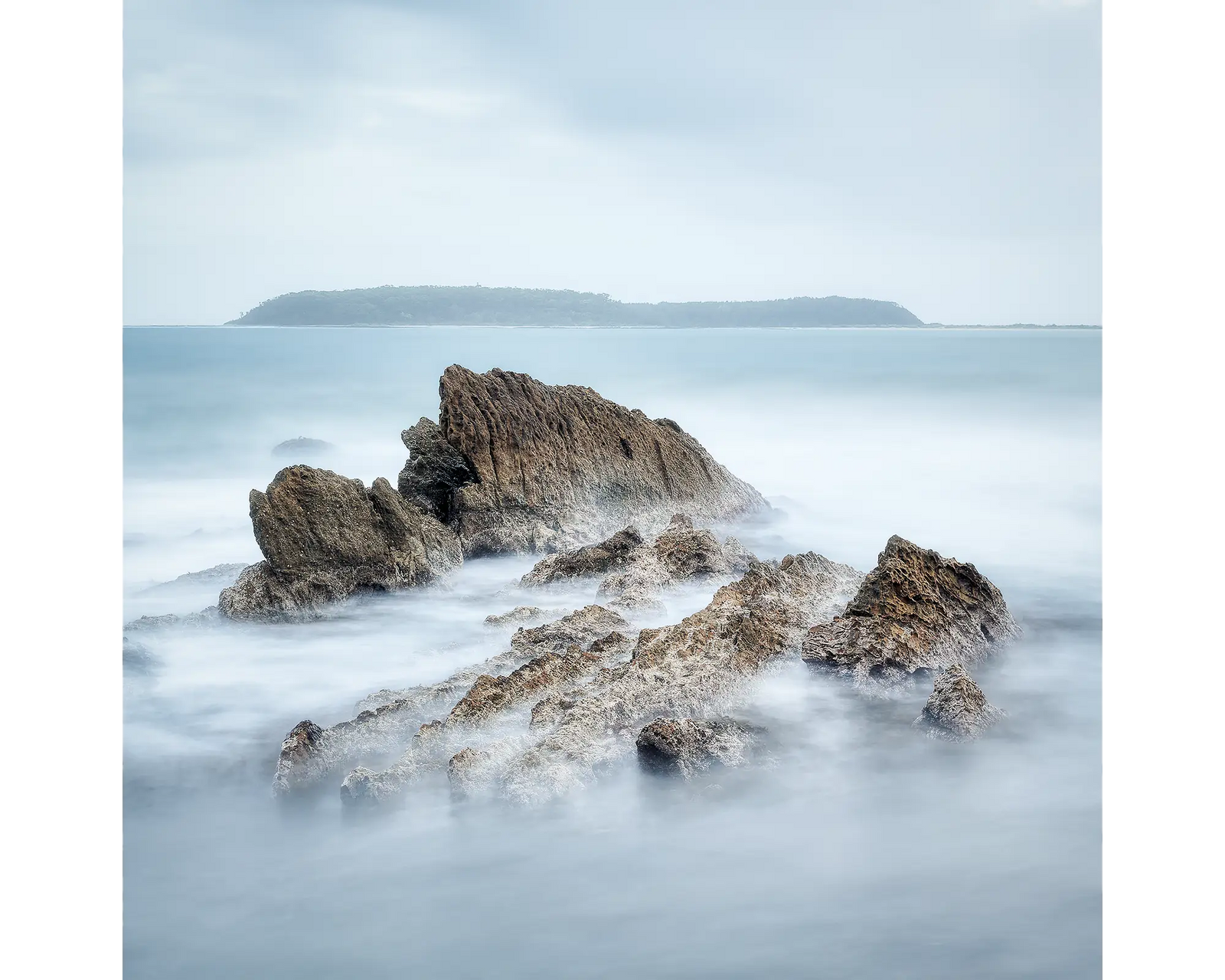 Rocks at Mossy Point with Broulee Island in the background, NSW. 