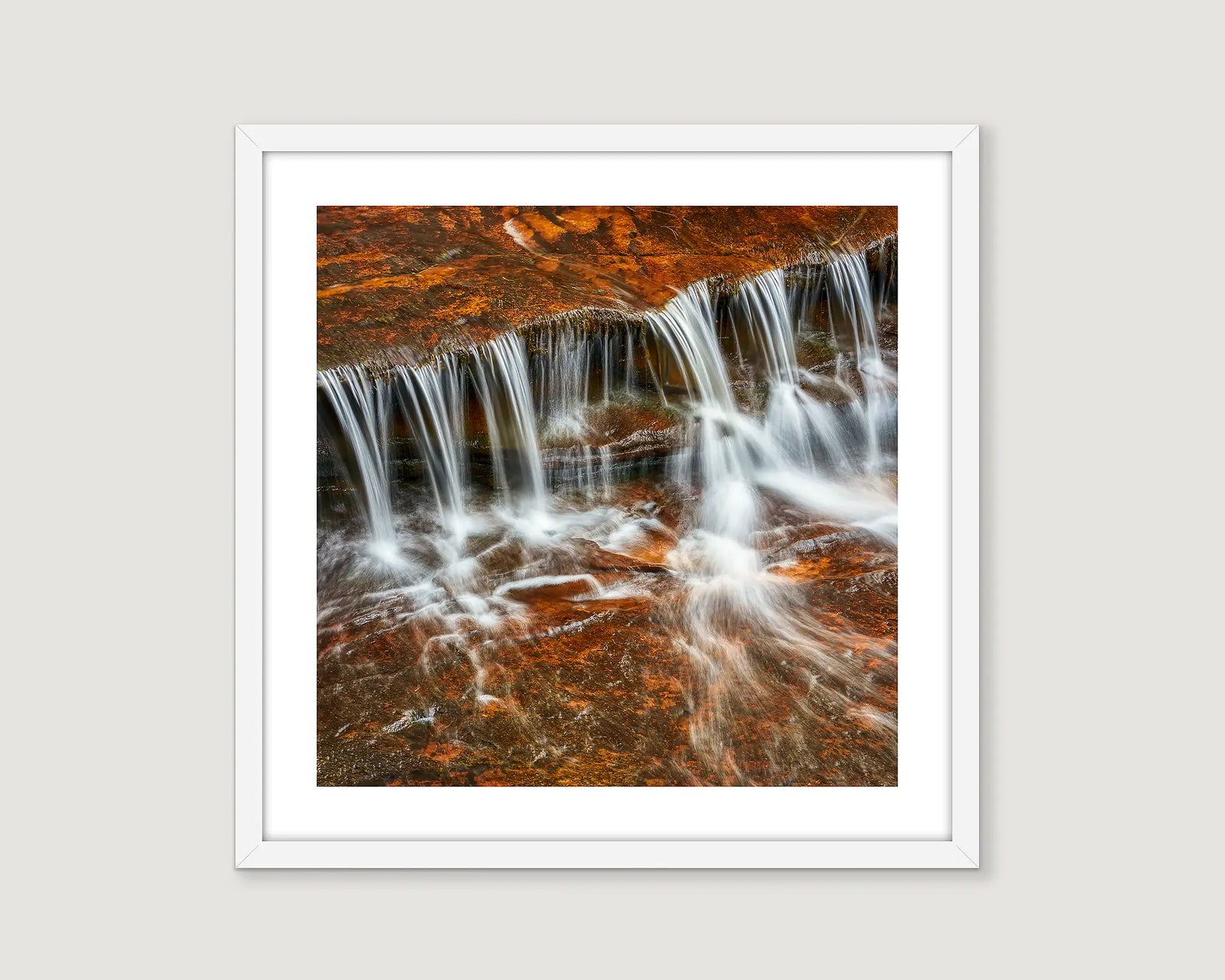 Photograph of water cascading over rocks.