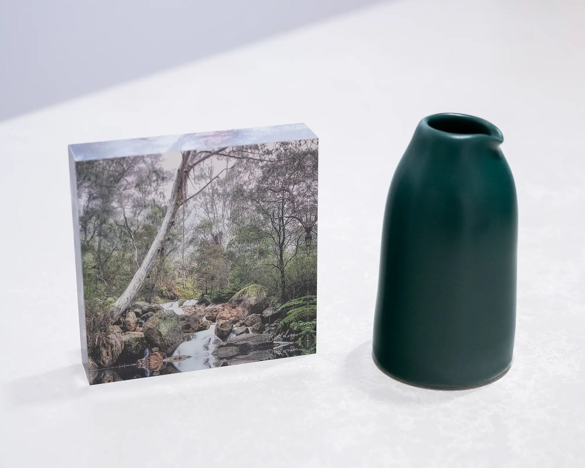 Mountain Flow. Acrylic block Mount Buffalo National Park, Victoria, on desk styled with a small vase.