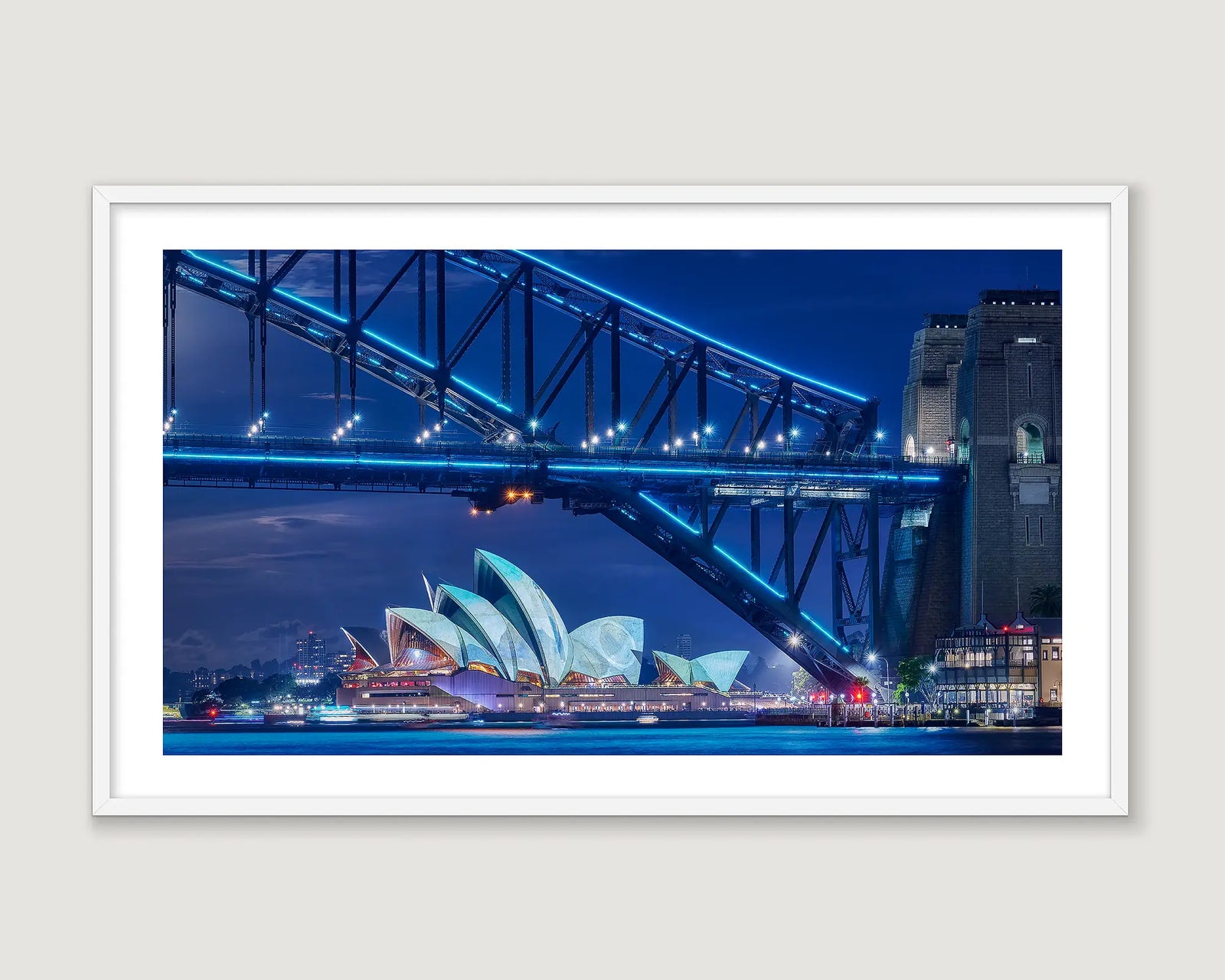 Framed photograph of Sydney Harbour Bridge and Sydney Opera House during the Vivid Festival.