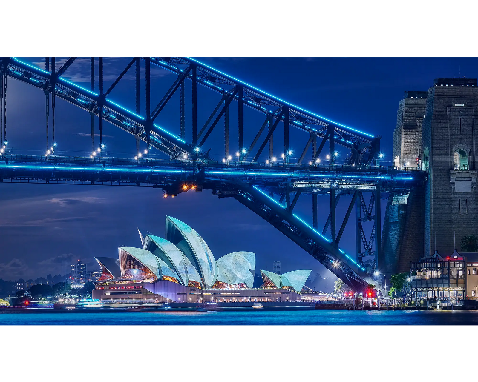 Sydney Harbour Bridge and Sydney Opera House lit up during Vivid Sydney.