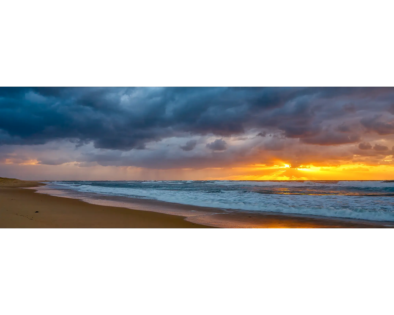 Stormy sunrise at Nobbys Beach, Newcastle, NSW.