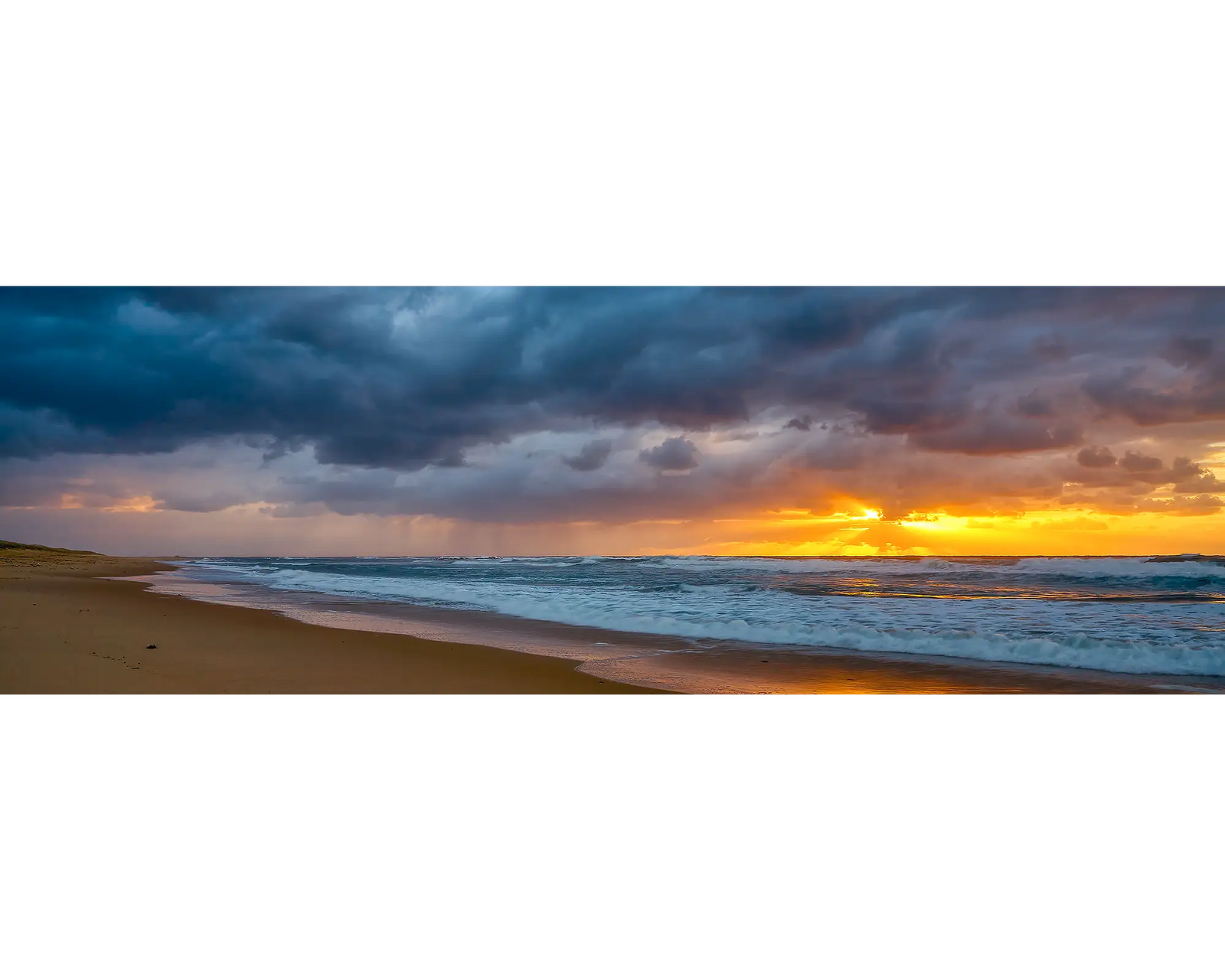 Newcastle Awakening. Stormy sunrise at Nobby's Beach, Newcastle, New South Wales, Australia.