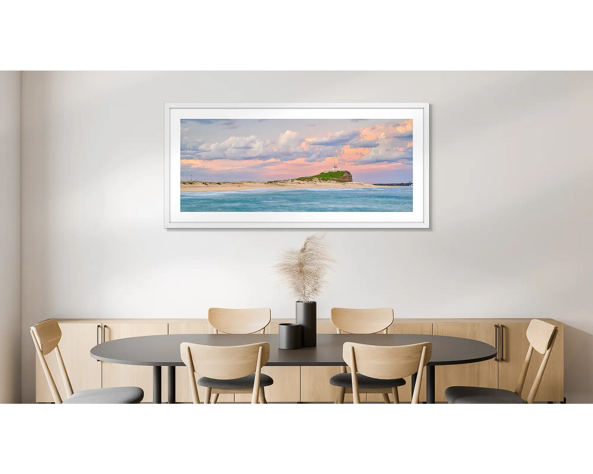 Newcastle Magic. Photographic wall art print of Nobbys beach, Newcastle, with a white frame and hung on a dining room wall. 