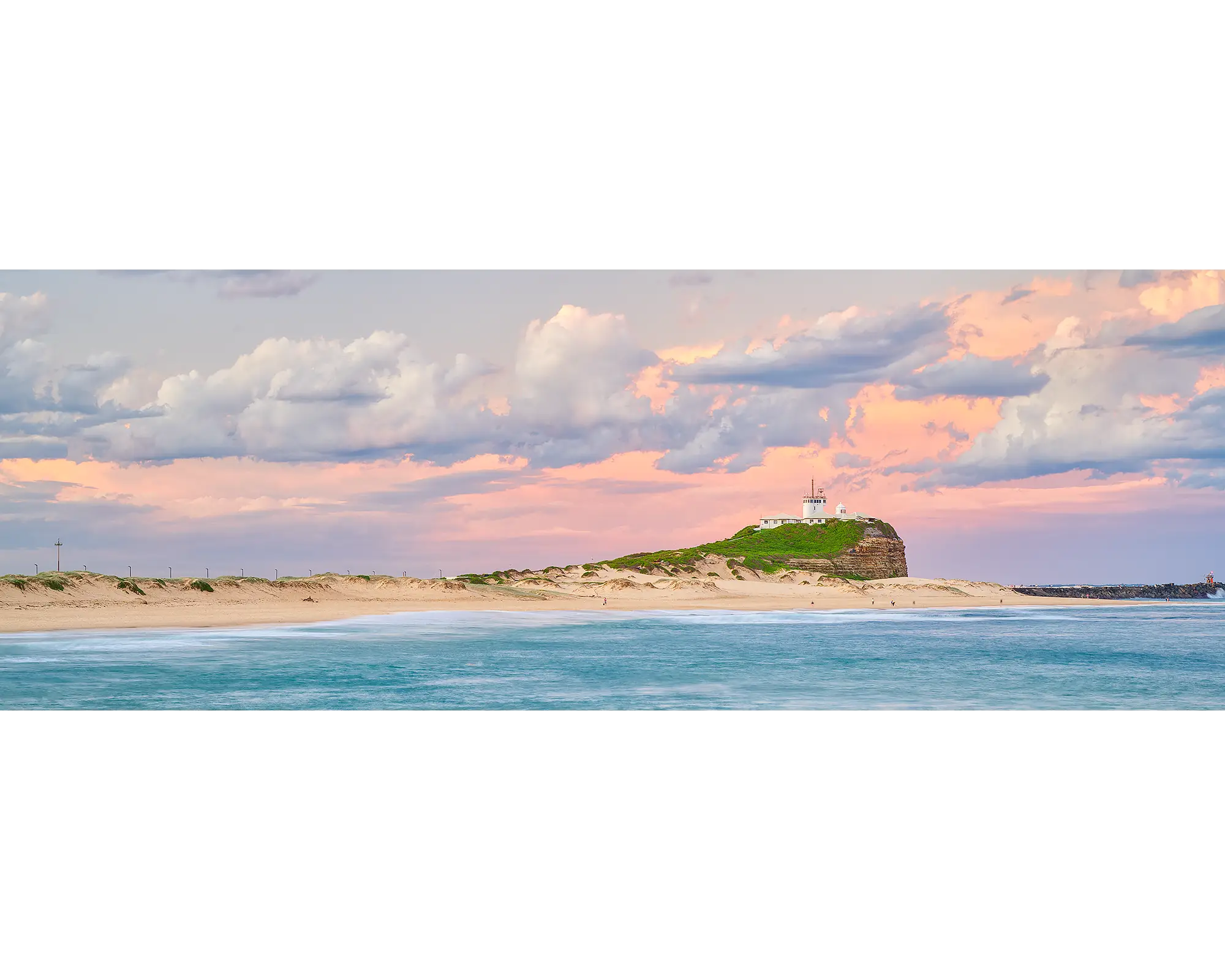 Newcastle Magic. Pink sunset over Nobbys Beach and lighthouse, Newcastle.