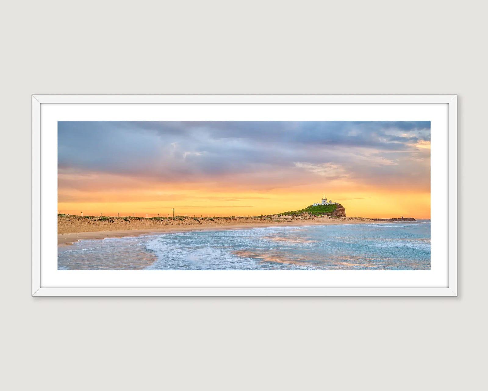 Framed landscape photograph of a beach and a golden sunrise.