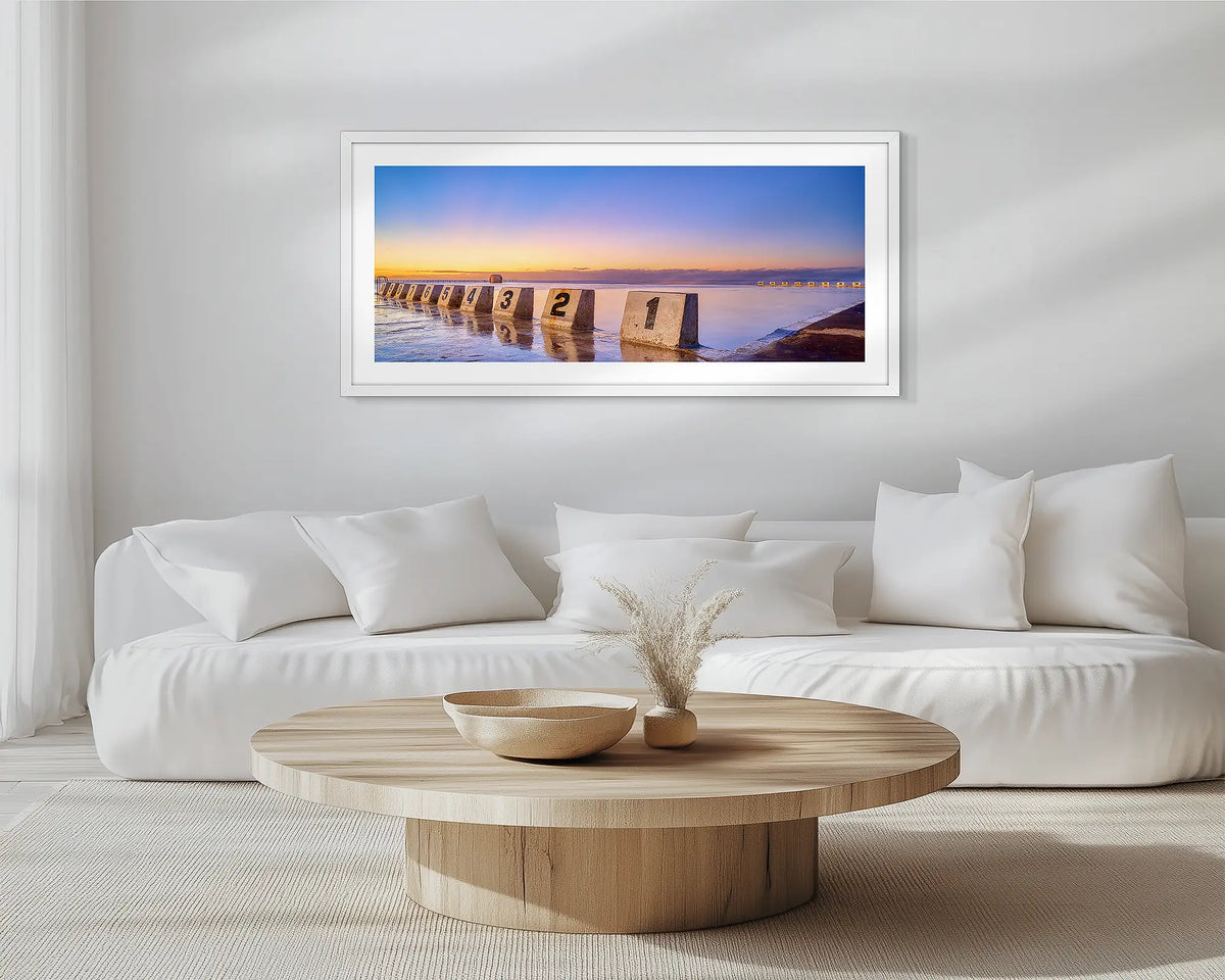 Numbers. White framed, Merewether Baths, wall art print, hung in a scandi-themed lounge room.