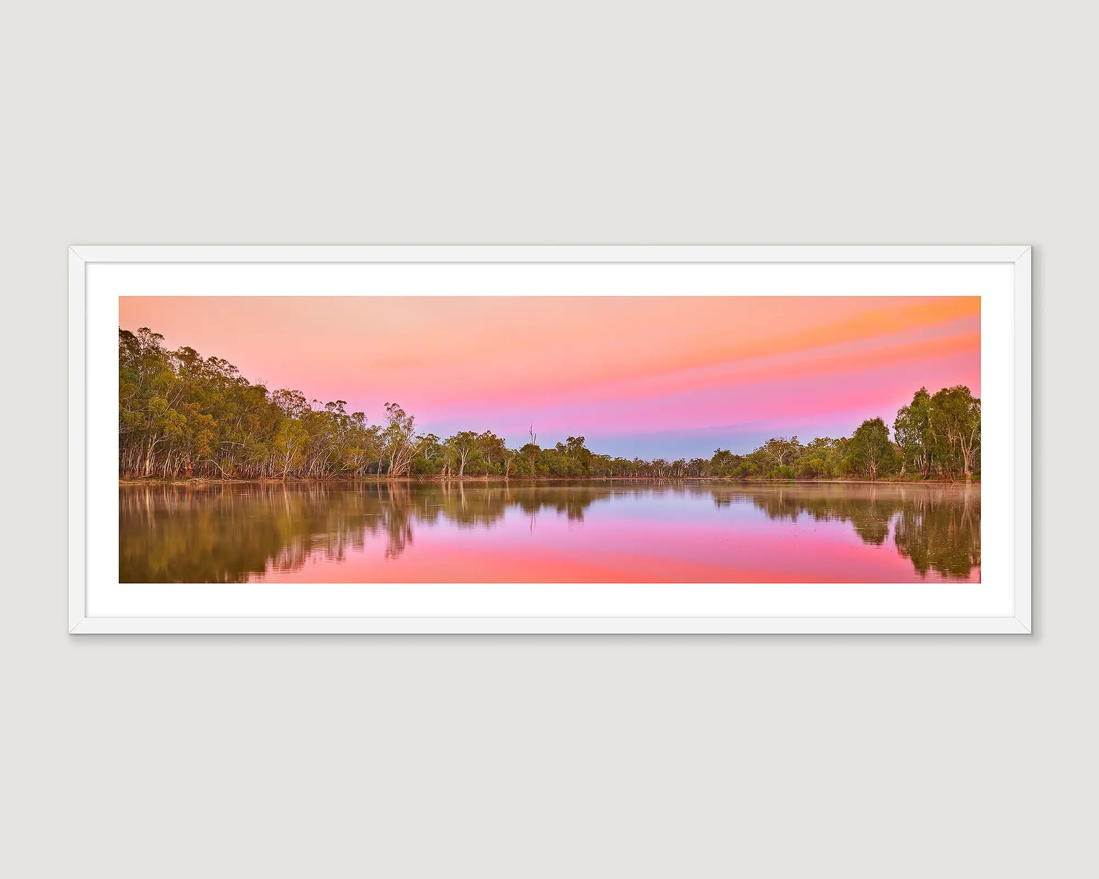 Framed landscape photograph of a river surrounded by gum trees with a colourful sunset.