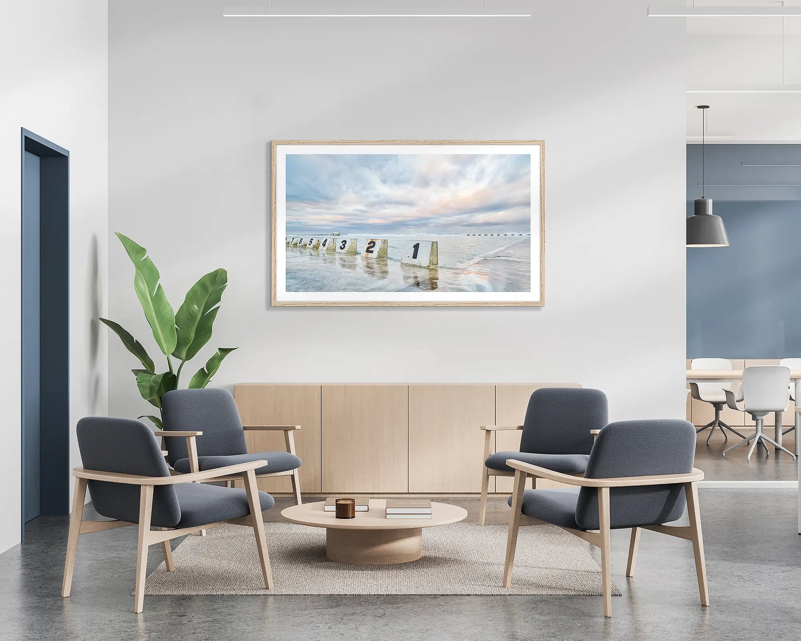 Ocean Baths. Framed wall art print of Merewether Ocean Baths, with a timber frame in a bright office lobby. 
