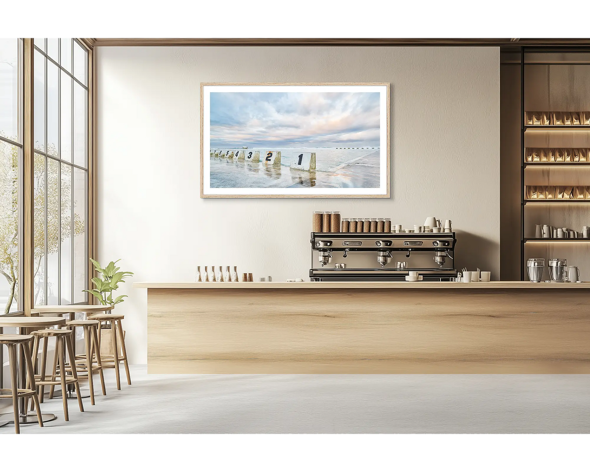 Ocean Baths. Merewether ocean baths wall art print with a timber frame hung in a cafe. 
