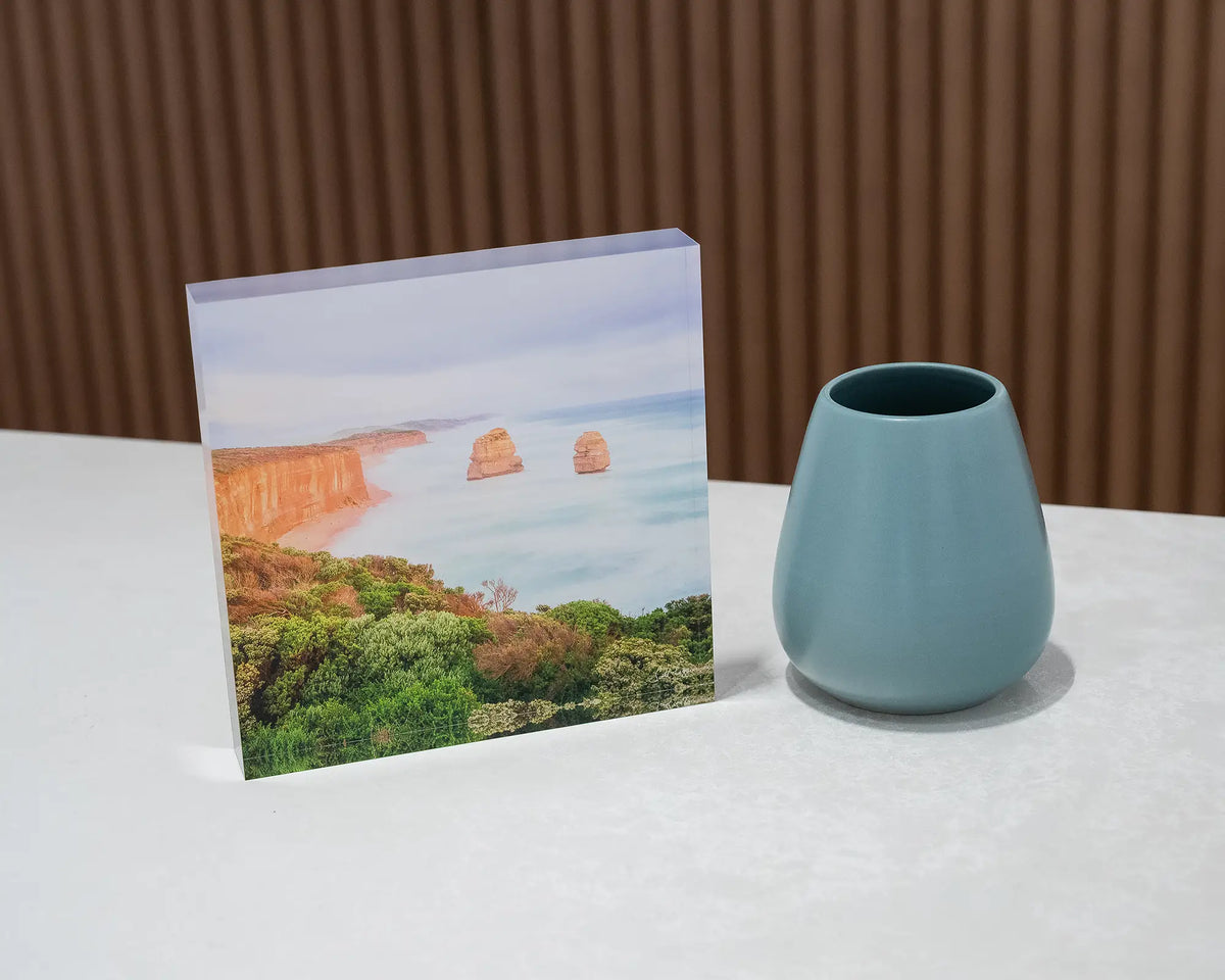 Ocean Blur. Acrylic block Great Ocean Road, Victoria, on desk styled with a vase.