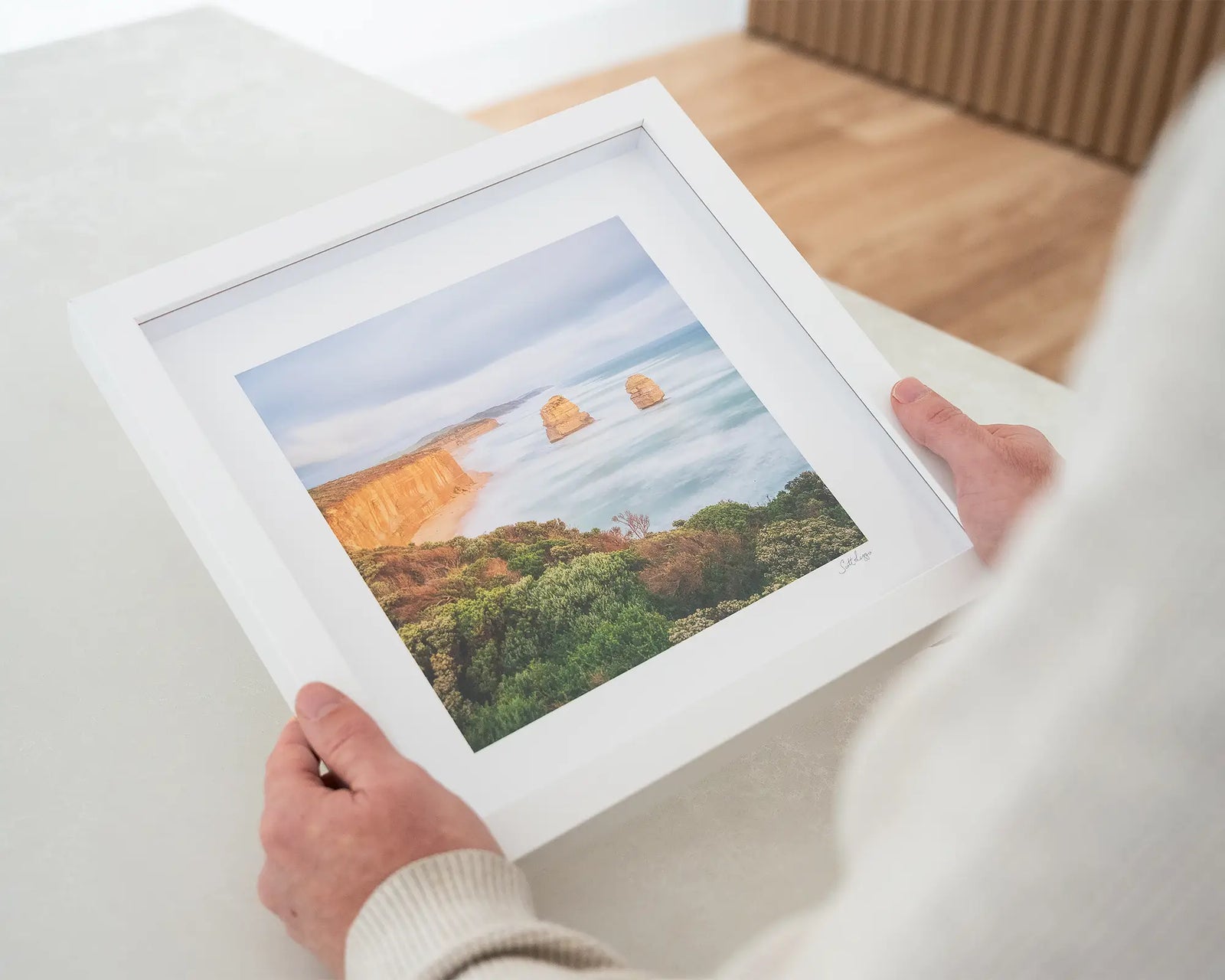 Framed photograph of a coastal landscape of Gog and Magog with cliffs and ocean.