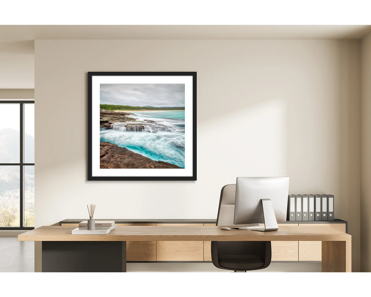 On the Rocks. Wall art print of South Durras with a black frame, in a home office. 