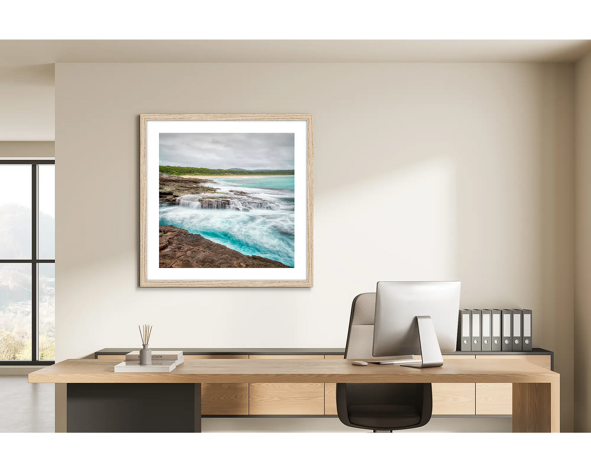 On the Rocks. Wall art print of South Durras with a Tasmanian Oak frame, in a home office. 