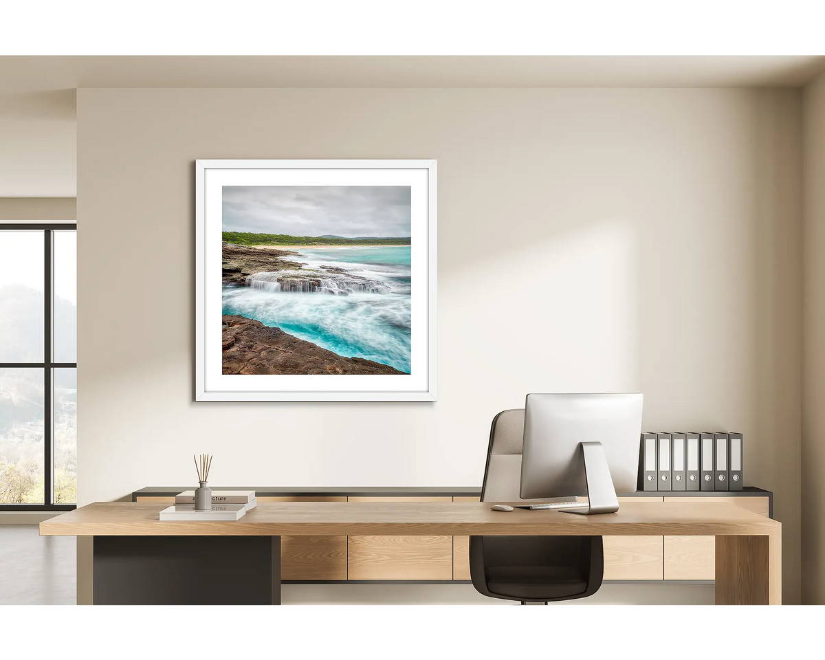 On the Rocks. Wall art print of South Durras with a white frame, in a home office. 