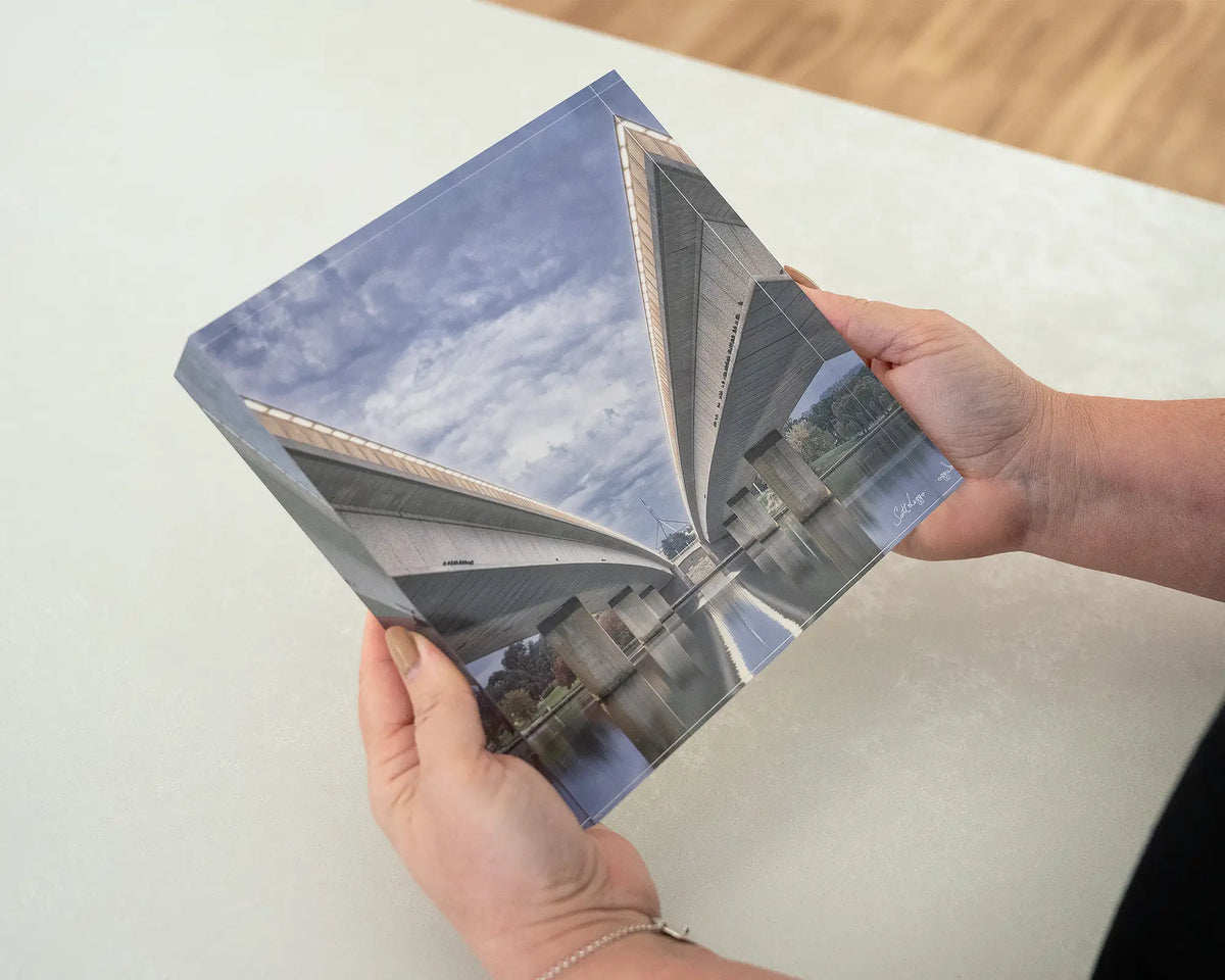One Direction. Acrylic block of Commonwealth Avenue Bridge, Canberra, being held in hands.