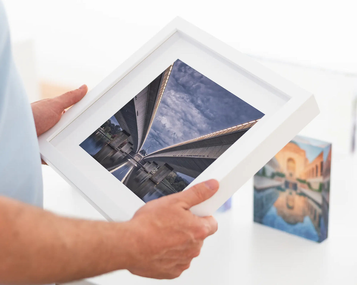 One Direction - Canberra artwork of bridges over lake in small white frame.
