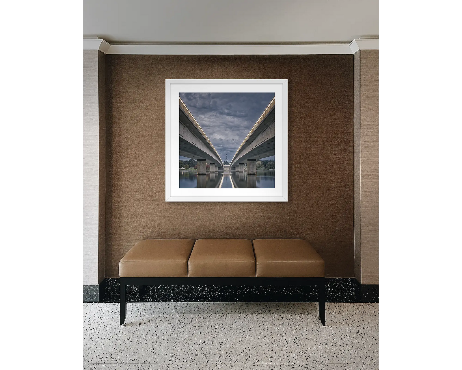 Framed photograph of bridges over a lake with a cloudy evening sky.