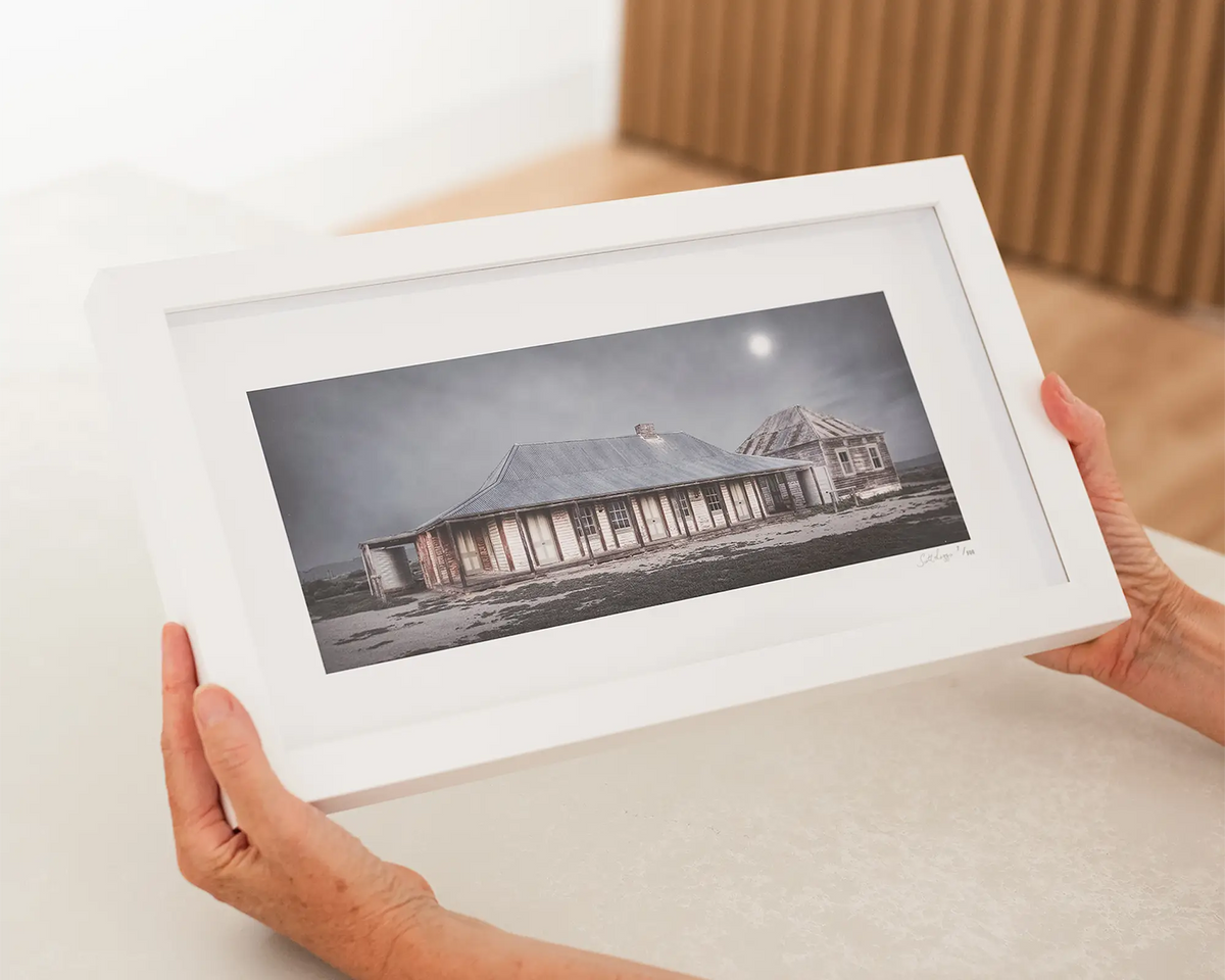 One Tree Hotel. New South Wales small frame artwork with white frame being held.