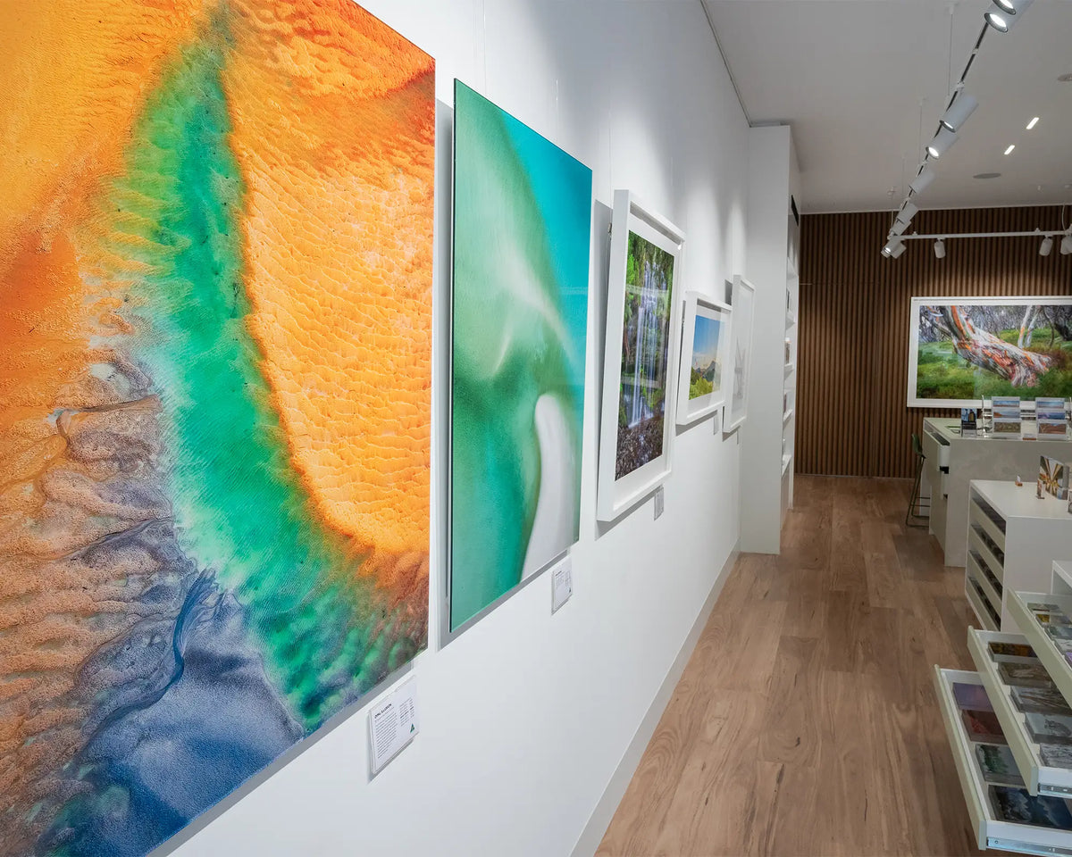 Opal Illusion. Aerial abstract coastal artwork frameless acrylic, hung in gallery space.