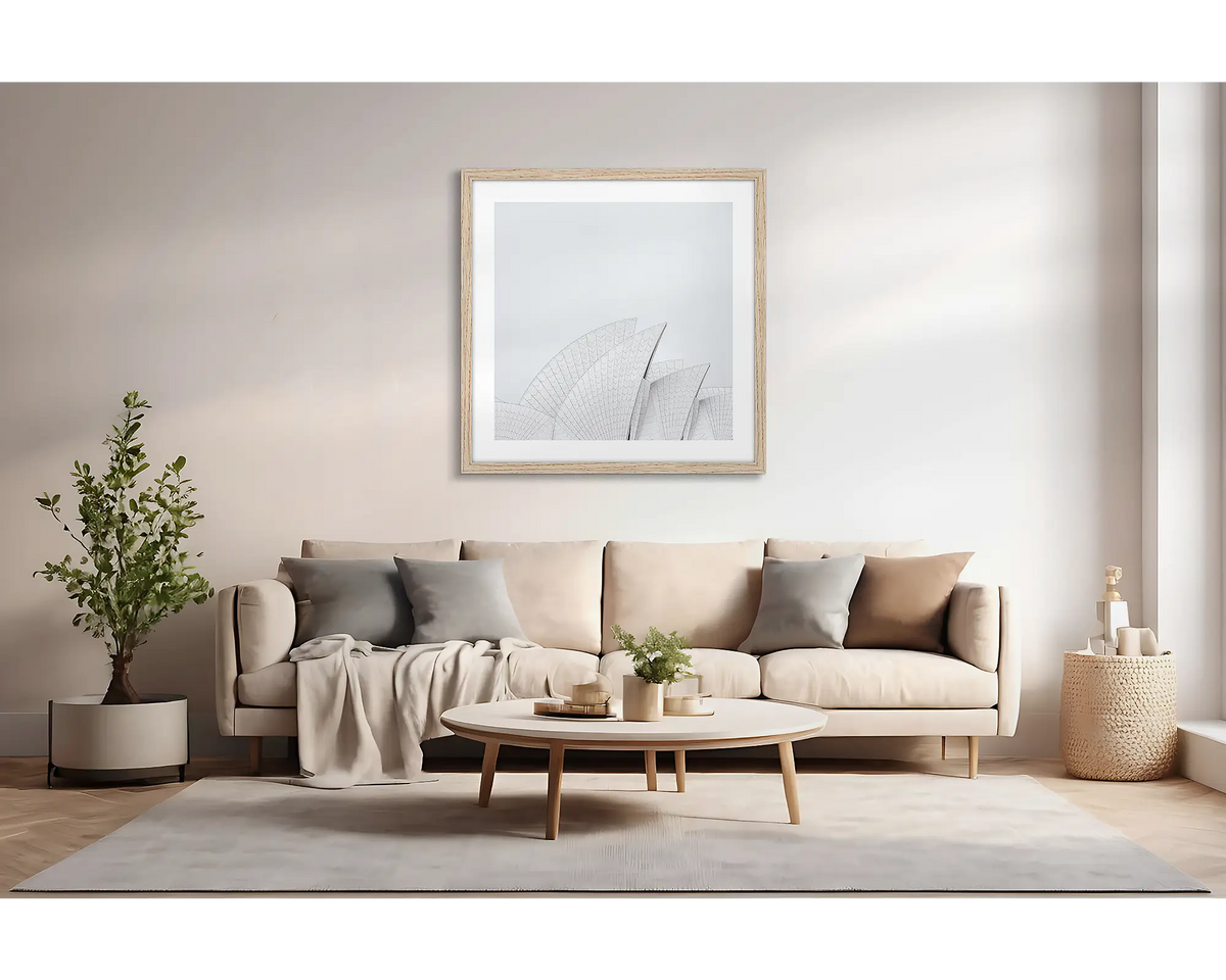 Opera House Curves. Large wall art print featuring sails of the Sydney Opera House, with a timber frame, hung above a couch. 