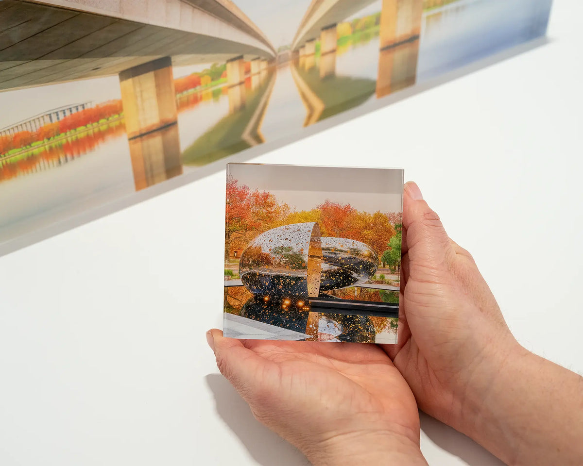 Orange Cocoon. Small acrylic block of Ouroboros sculpture National Gallery of Australia, being hand held.