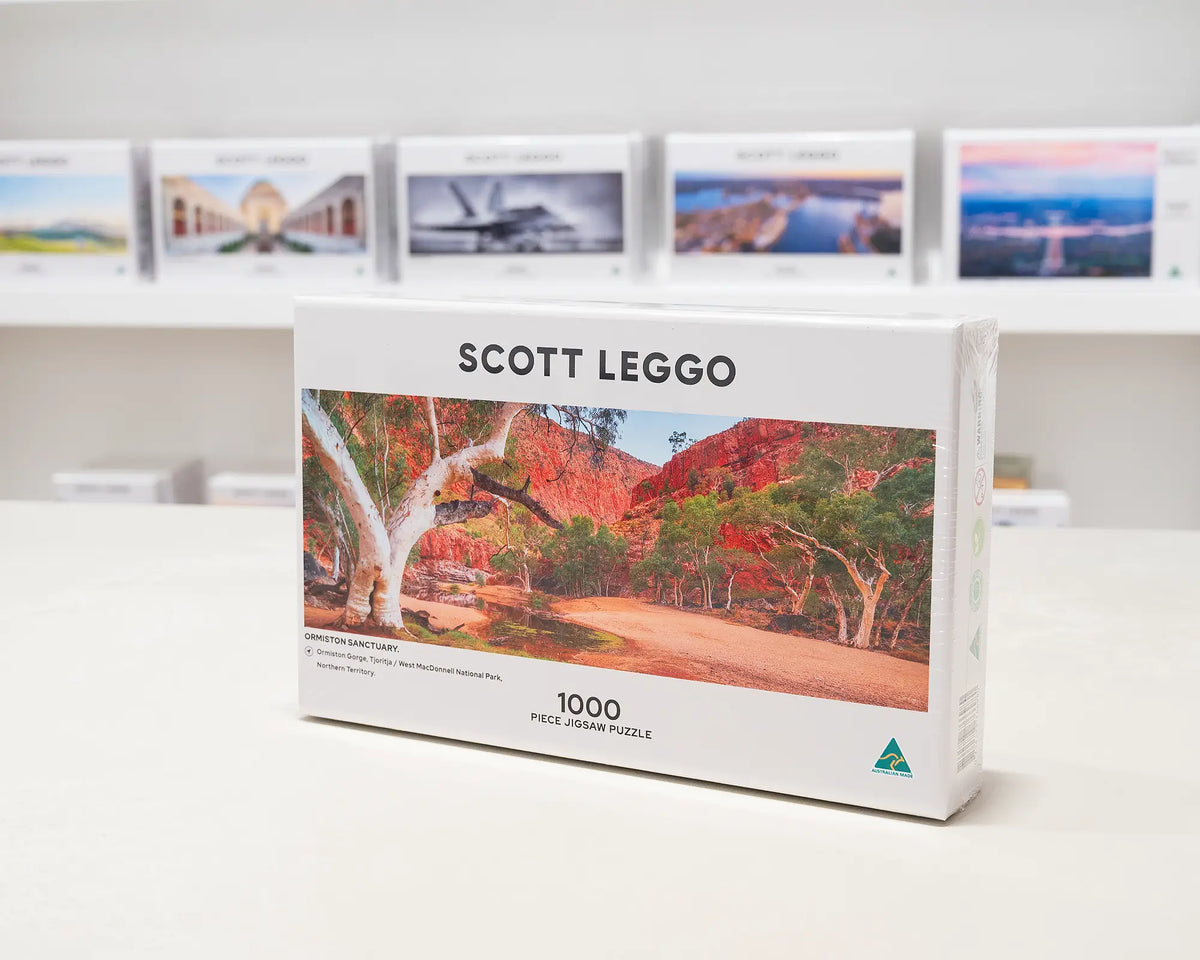 Ormiston Sanctuary 1000 piece jigsaw puzzle box sitting on table in front of other puzzle boxes.