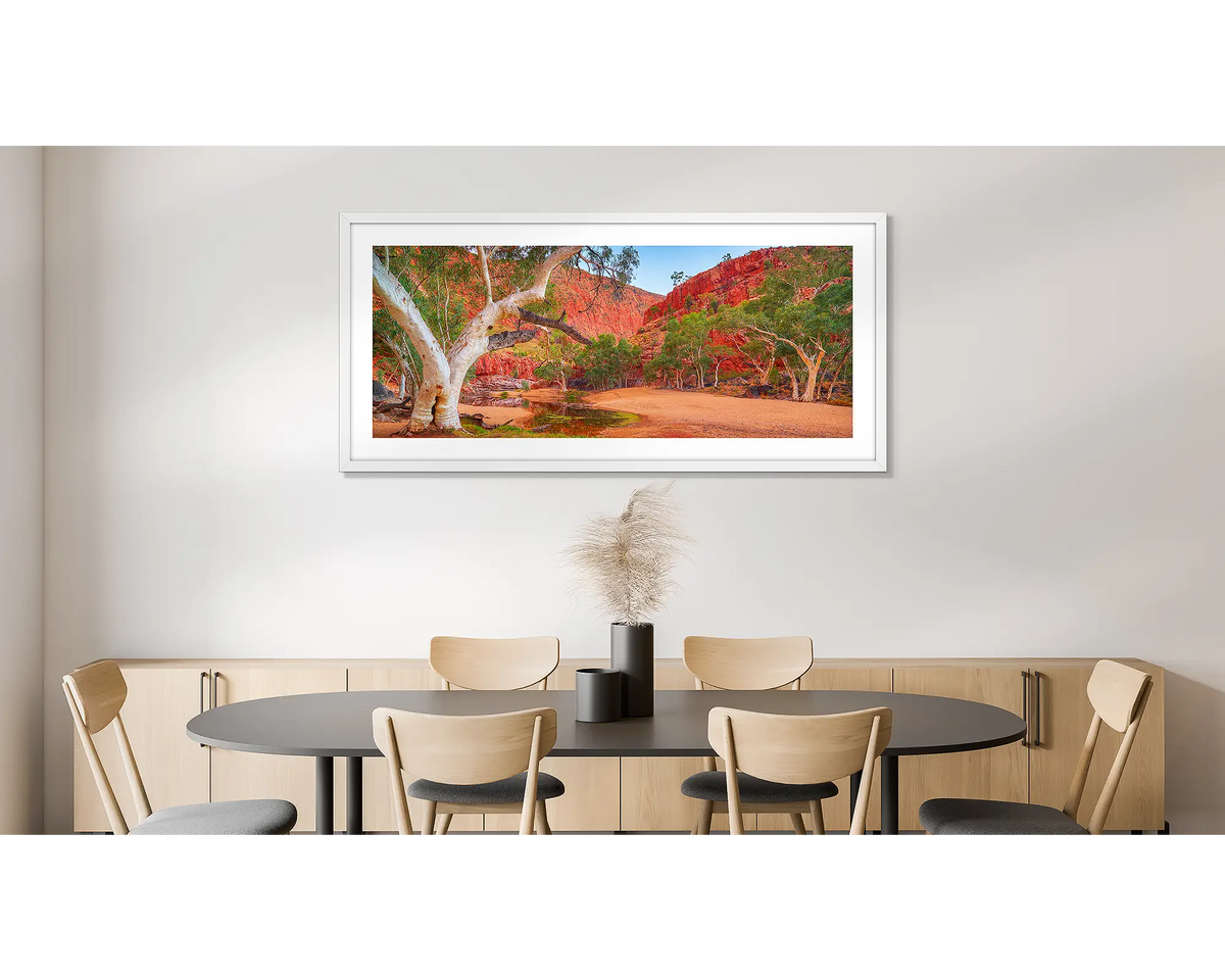 Ormiston Sanctuary. Photographic wall art print of a ghost gum at Ormiston Gorge, with a white frame, hung on a dining room wall.