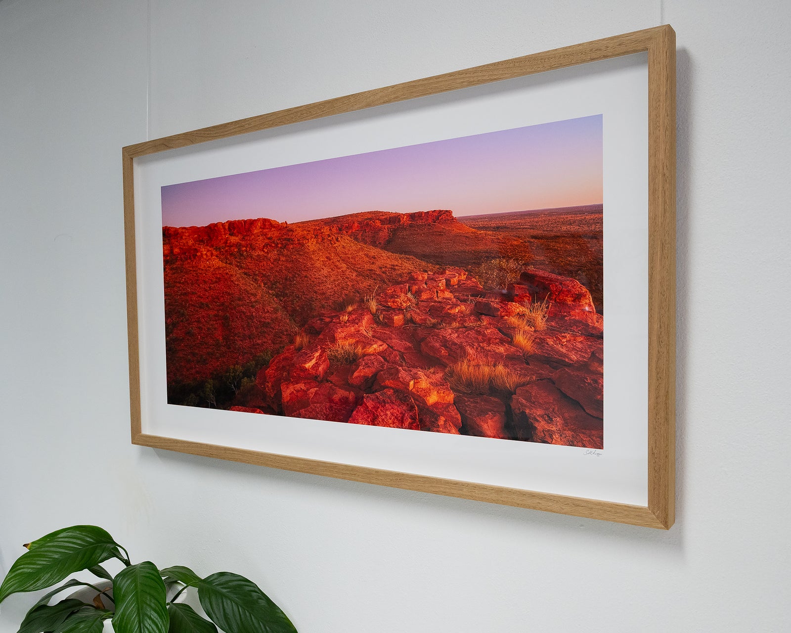 Framed photograph of the rocky cliffs of Kings Canyon under a blue sky.