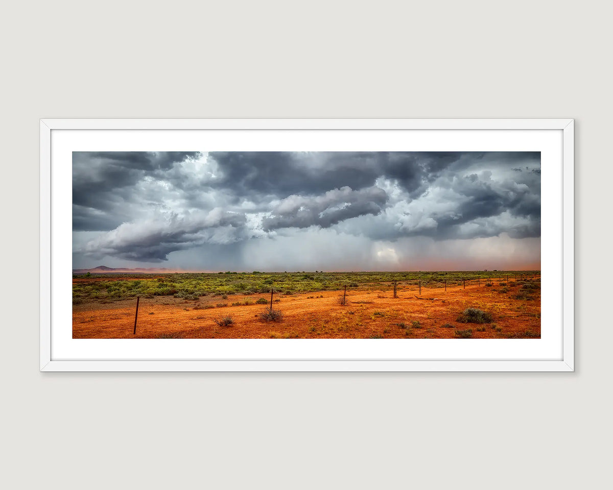 Framed photograph of the outback in Australia with a dark storm approaching.