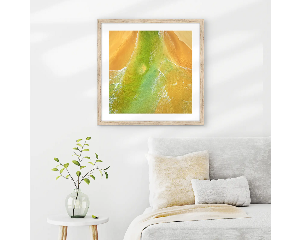 Outflow. Abstract wall art print of Durras Lake, framed in a timber frame and hung above a bed. 