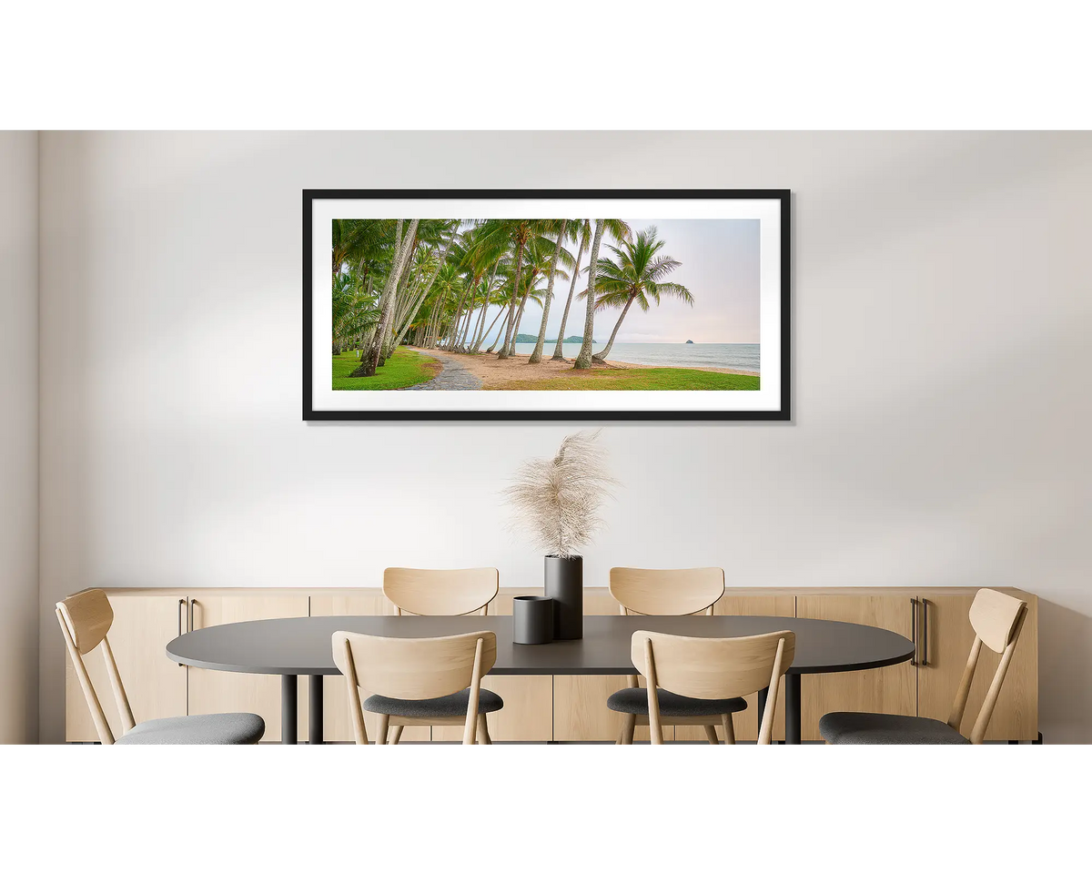 Palm Tree Tunnel. Photographic wall art print of Palm Cove, Queensland, with a black frame, hung on a dining room wall. 