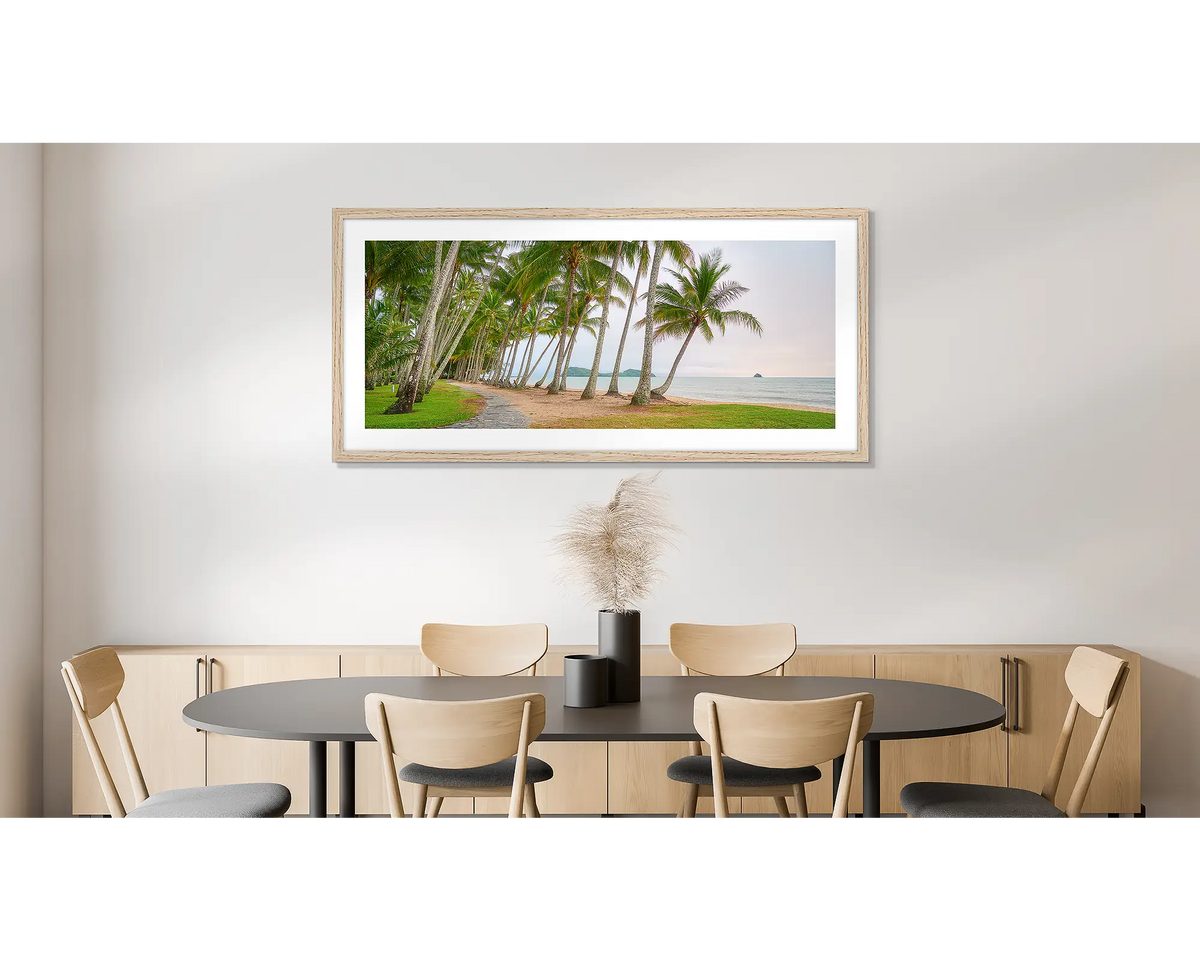 Palm Tree Tunnel. Photographic wall art print of Palm Cove, Queensland, with a timber frame, hung on a dining room wall. 