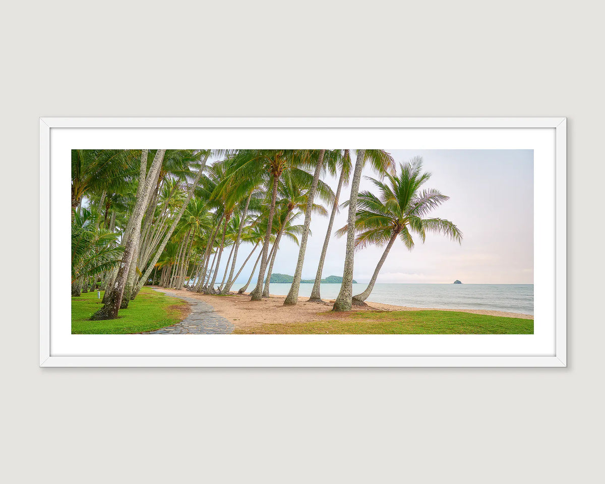 Framed photograph of palm trees and the ocean.