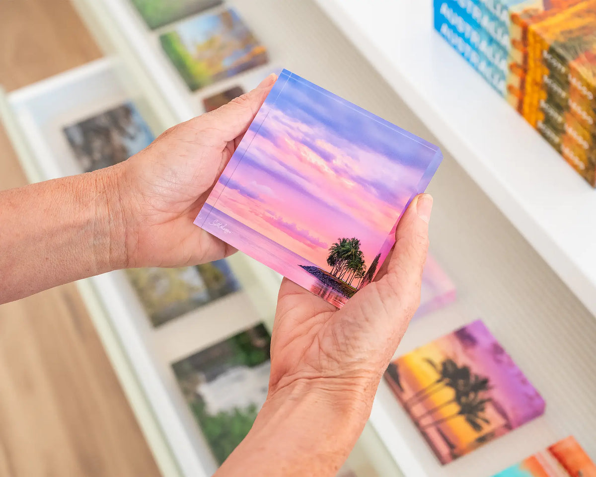 Paradise Palms. 10cm acrylic block of Port Douglas Queensland, held in hands.