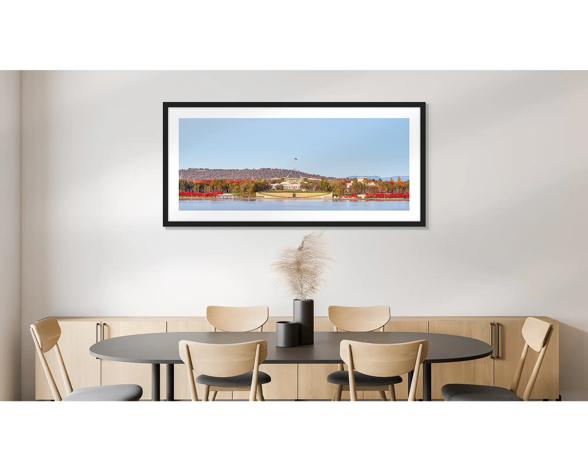 Parliamentary Reds. Photographic wall art print of old and new Parliament House, framed in a black frame and hung on a dining room wall. 