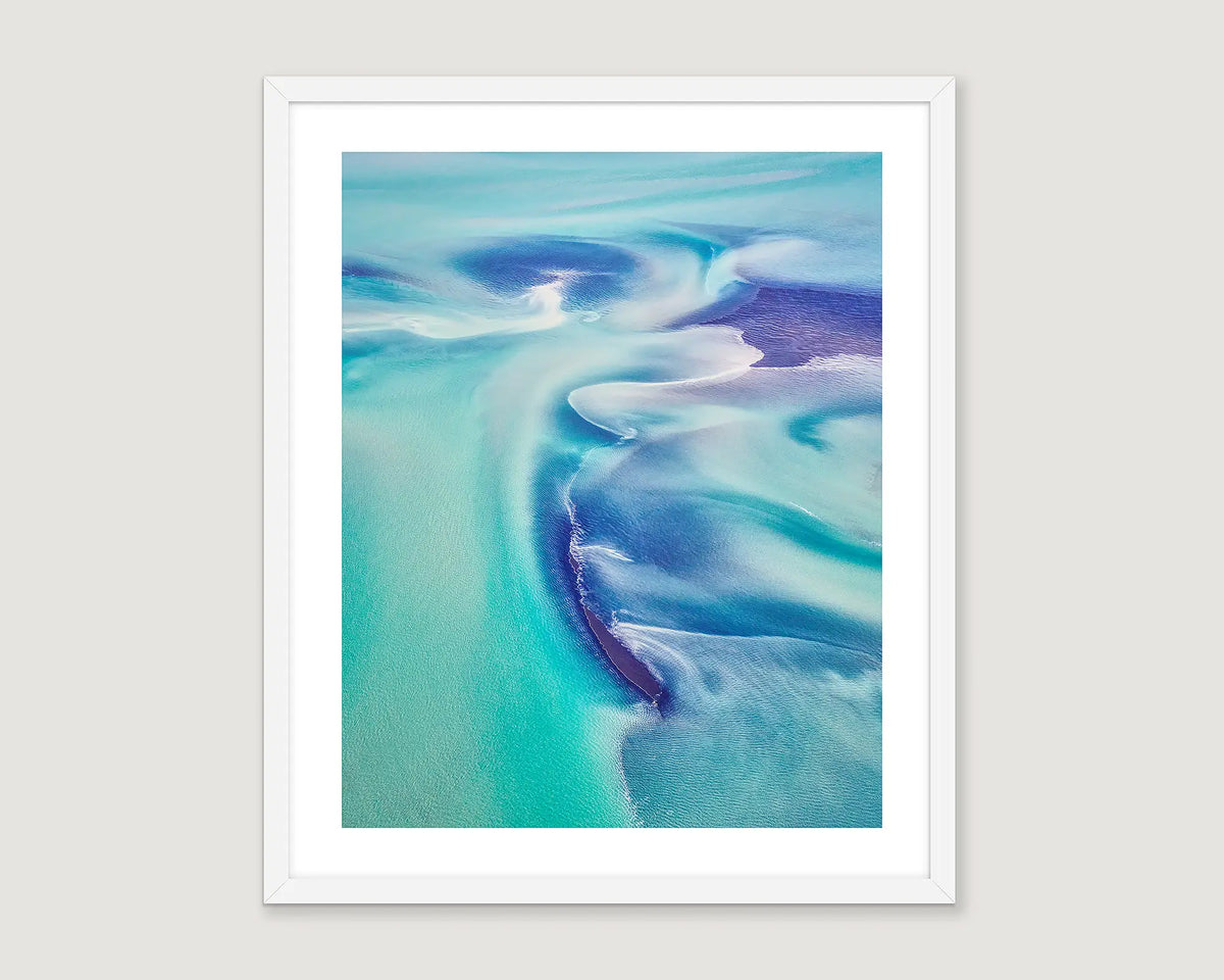 Framed abstract photograph of waves in blue, turquoise and white.